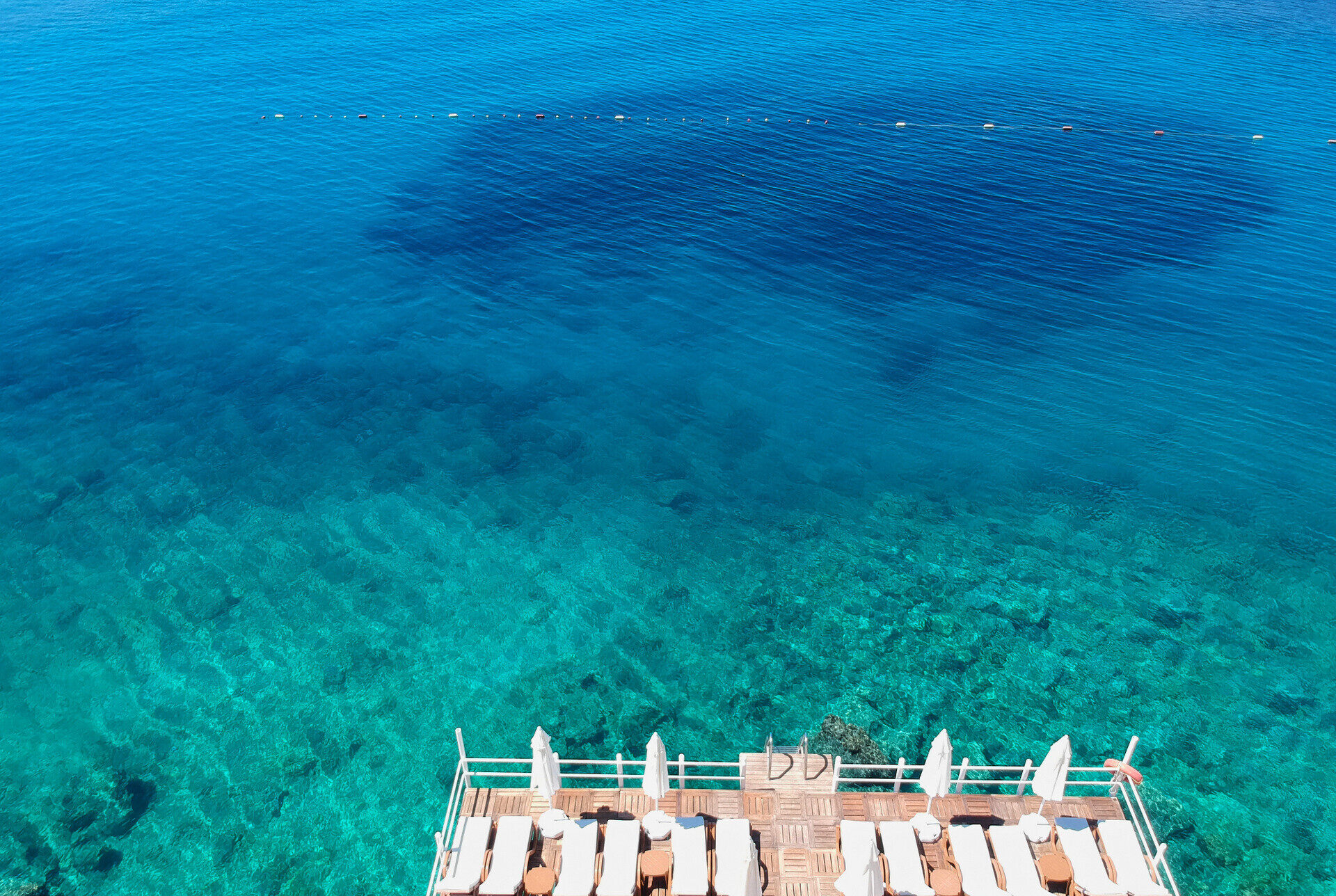Sunbeds on the hotel swimming platform seen from above, Kaş