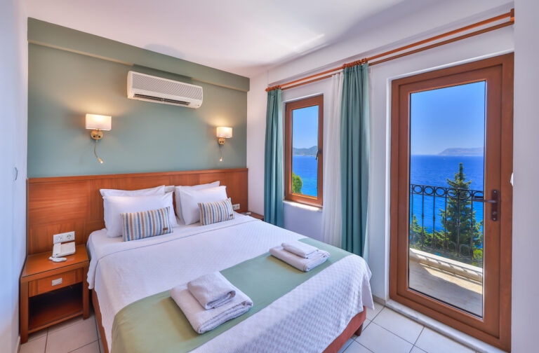 Deluxe Room with a double bed and the balcony door open to the sea, Medusa Hotel Kaş