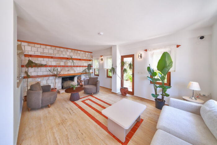 Lounge with a stone fireplace and seating area, Medusa Hotel Kaş